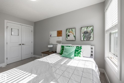Bedroom featuring a double-pane window with white blinds, light gray wall paint, and white trim - 1440 Darby Green, Edmonton, AB - Indoor Photo Showing Bedroom