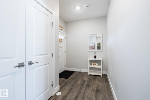 Entryway featuring wood-finish flooring, light gray wall paint, and crisp white trim - 1440 Darby Green, Edmonton, AB - Indoor Photo Showing Other Room