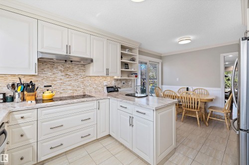 Kitchen featuring light-toned cabinetry, a stainless steel range hood, and an integrated cooktop - 227 Westridge Road, Edmonton, AB - Indoor Photo Showing Kitchen With Upgraded Kitchen