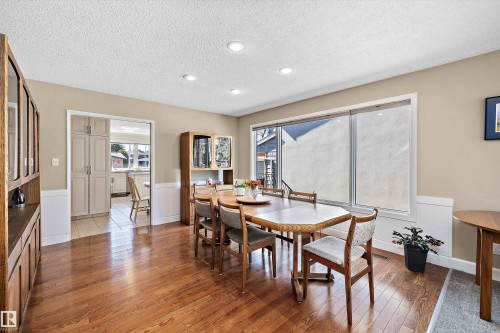 Spacious dining area featuring wood-finish flooring, recessed lighting, and a large window - 227 Westridge Road, Edmonton, AB - Indoor Photo Showing Dining Room