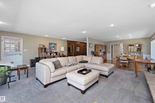 Open-concept living area featuring light-colored walls, recessed lighting, and a white Dutch door with glass panels - 227 Westridge Road, Edmonton, AB - Indoor Photo Showing Living Room