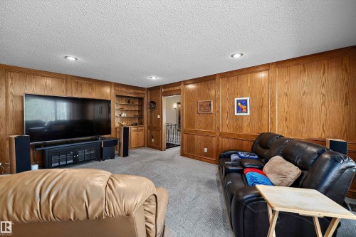 Wood-paneled room featuring recessed lighting, a built-in shelving unit, and wall-to-wall carpeting - 227 Westridge Road, Edmonton, AB - Indoor