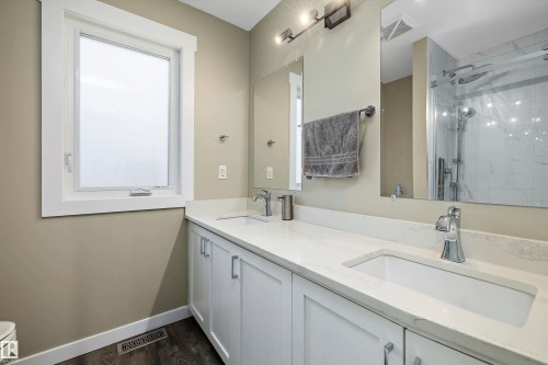 Double vanity with integrated rectangular sinks, white cabinetry, chrome fixtures, and a white countertop - 227 Westridge Road, Edmonton, AB - Indoor Photo Showing Bathroom