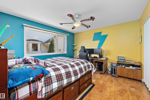 Bedroom featuring a window with integrated blinds, wood-finish flooring, and a ceiling fan with light fixture - 227 Westridge Road, Edmonton, AB - Indoor Photo Showing Bedroom