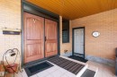 Double wood-panel entry doors set within a brick facade - 227 Westridge Road, Edmonton, AB  - Outdoor With Exterior 