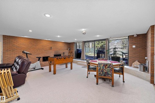 Spacious room featuring brick wall accents, recessed lighting, and a built-in fireplace - 227 Westridge Road, Edmonton, AB - Indoor Photo Showing Other Room