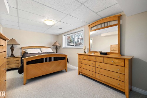 Carpeted room featuring a drop ceiling with recessed lighting and a single window with blinds - 227 Westridge Road, Edmonton, AB - Indoor Photo Showing Bedroom