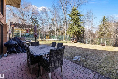 Expansive backyard featuring a red paver patio, a pergola-covered area, and mature trees - 227 Westridge Road, Edmonton, AB - Outdoor With Deck Patio Veranda