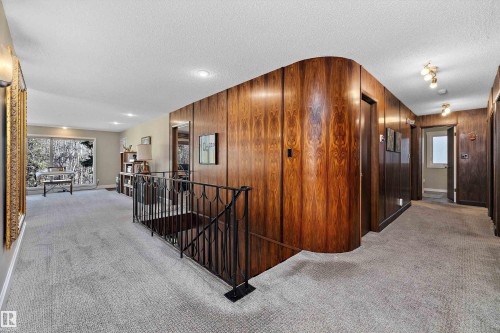 Upper-level hallway featuring wood-finish paneling, light-toned carpeting, and recessed lighting - 227 Westridge Road, Edmonton, AB - Indoor Photo Showing Other Room
