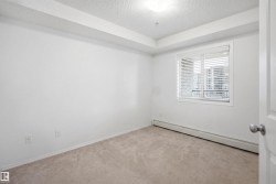 Bright room featuring neutral carpeting, white walls, and a window with horizontal blinds - 