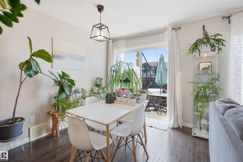 Carpeted upper-level landing with light neutral wall paint - 7323 24 Ave, Edmonton, AB - Indoor Photo Showing Other Room