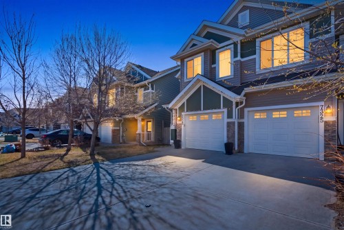 Multi-level residence featuring a double garage, stone accents, and a combination of horizontal and shake siding - 7323 24 Ave, Edmonton, AB - Outdoor With Facade