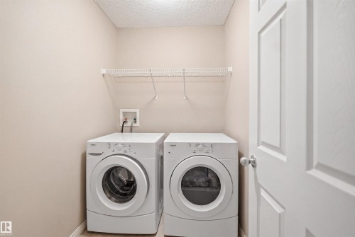 Interior space featuring light gray painted walls, light-colored carpeting, a white railing, and white trim - 7323 24 Ave, Edmonton, AB - Indoor Photo Showing Other Room