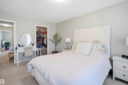 Townhome exterior featuring multi-toned siding, stone veneer accents, and white trim - 7323 24 Ave, Edmonton, AB - Outdoor