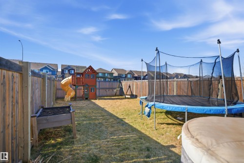 Expansive backyard featuring a natural grass lawn and wood fencing - 7323 24 Ave, Edmonton, AB - Outdoor
