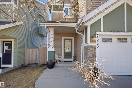 Expansive backyard featuring a manicured lawn, a wood deck, a built-in hot tub, and a privacy fence - 7323 24 Ave, Edmonton, AB - Outdoor With Deck Patio Veranda