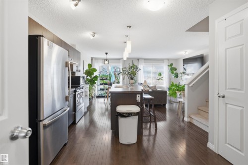 Carpeted bedroom featuring a contemporary ceiling fixture, light gray walls, and white trim - 7323 24 Ave, Edmonton, AB - Indoor Photo Showing Bedroom