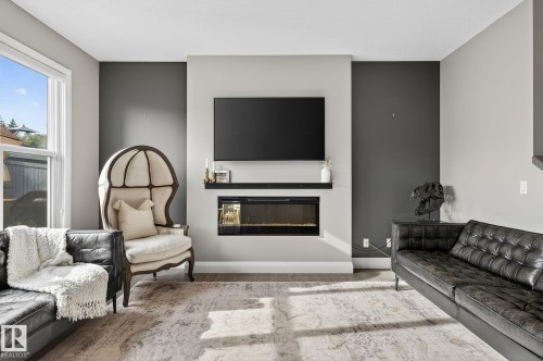 Contemporary living area featuring a built-in electric fireplace with an integrated mantel shelf - 1737 Dumont Crescent, Edmonton, AB - Indoor Photo Showing Living Room With Fireplace
