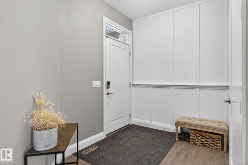 Entryway featuring wood-finish flooring and a contemporary white door with an overhead transom window - 1737 Dumont Crescent, Edmonton, AB - Indoor Photo Showing Other Room