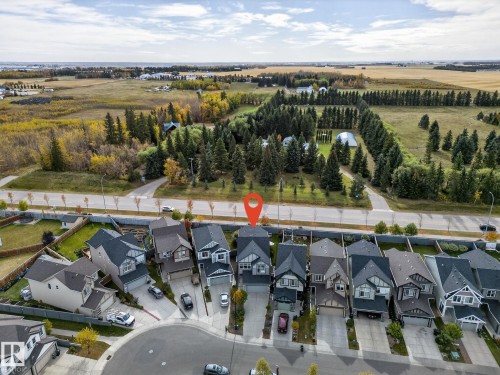 Aerial perspective showcasing a residential development bordering expansive natural landscapes and agricultural fields - 1737 Dumont Crescent, Edmonton, AB - Outdoor With View