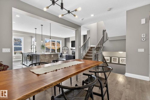 Open-concept interior featuring light gray wall tones and wood-finish flooring - 1737 Dumont Crescent, Edmonton, AB - Indoor Photo Showing Dining Room