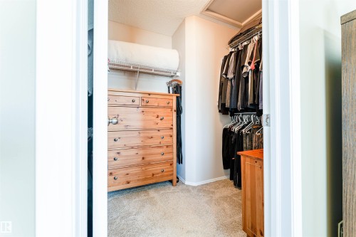 Carpeted closet with wire shelving and clothes hanging rods - 847 Blacklock Way, Edmonton, AB - Indoor