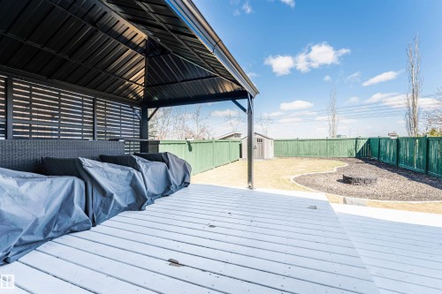White painted deck surface featuring a black metal gazebo with slatted privacy walls - 847 Blacklock Way, Edmonton, AB - Outdoor With Deck Patio Veranda With Exterior