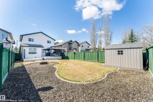 Rear exterior featuring a two-story design, an expansive patio, and a built-in fire pit - 847 Blacklock Way, Edmonton, AB - Outdoor With Deck Patio Veranda