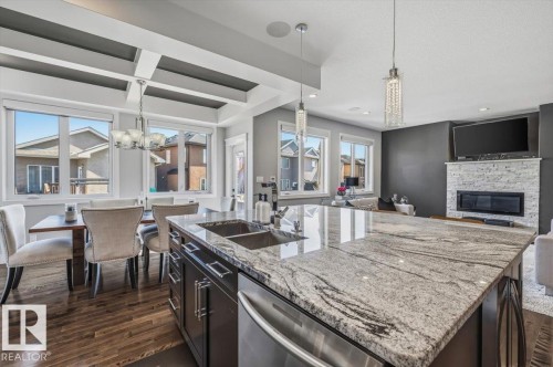 819 Albany Cove, Edmonton, AB - Indoor Photo Showing Kitchen With Fireplace With Double Sink With Upgraded Kitchen