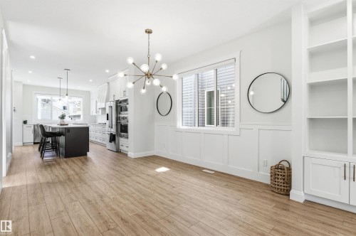 Dedicated dining space with a huge window and custom lighting fixture. - 10430 143 Street, Edmonton, AB - Indoor