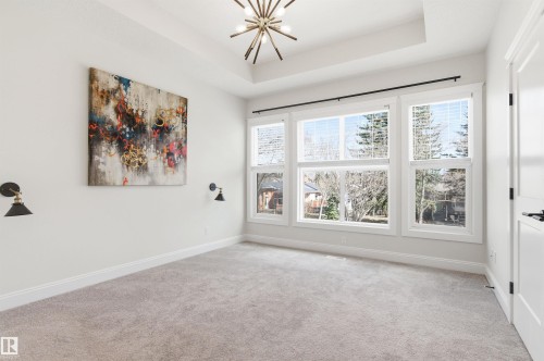 Well lit bedroom with a large walk in closet. - 10430 143 Street, Edmonton, AB - Indoor Photo Showing Other Room