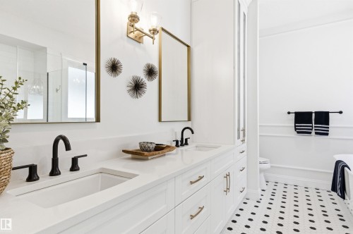 This GORGEOUS ensuite features heated floors, designer lighting, soaker tub and separate shower - 10430 143 Street, Edmonton, AB - Indoor Photo Showing Bathroom