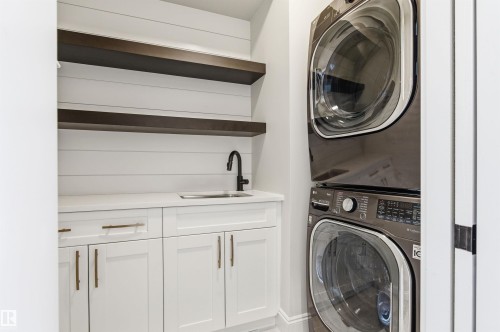 Note ample storage and a sink - 10430 143 Street, Edmonton, AB - Indoor Photo Showing Laundry Room