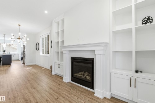 Plenty of shelving to display all your photos, collectibles, knick knacks. - 10430 143 Street, Edmonton, AB - Indoor With Fireplace