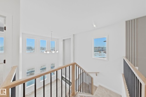 This property features an inviting interior with light-toned walls and large windows that provide abundant natural light - 17 Trill Point(E), Spruce Grove, AB - Indoor Photo Showing Other Room