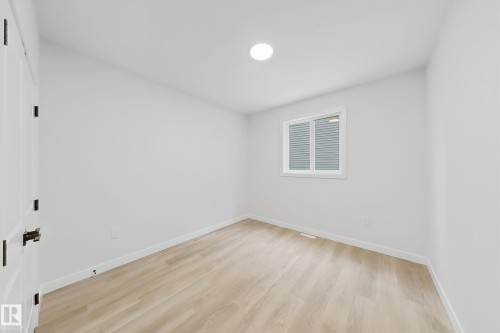 This room features light-colored flooring, white walls, and a window with blinds - 17 Trill Point(E), Spruce Grove, AB - Indoor Photo Showing Other Room