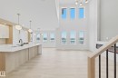 The open concept interior features light wood flooring throughout - 17 Trill Point(E), Spruce Grove, AB  - Indoor 