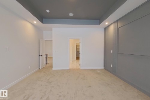 The room features plush carpeting and a tray ceiling with recessed lighting - 17 Trill Point(E), Spruce Grove, AB - Indoor Photo Showing Other Room