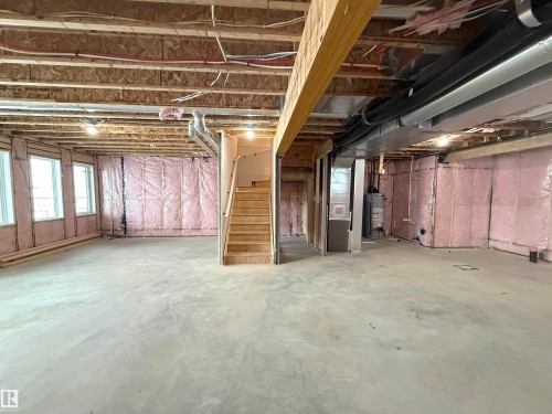 Expansive unfinished lower level with concrete flooring, visible wood framing, and insulation - 17 Trill Point(E), Spruce Grove, AB - Indoor Photo Showing Basement