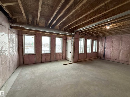 Expansive unfinished interior space featuring exposed ceiling joists, concrete flooring, and insulated walls - 17 Trill Point(E), Spruce Grove, AB - Indoor Photo Showing Other Room