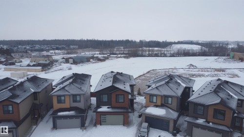 Properties featuring modern exteriors and attached garages, situated within a community offering open views of natural landscapes - 17 Trill Point(E), Spruce Grove, AB - Outdoor With Facade