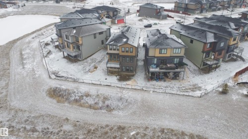 This property features a modern multi-story exterior with balconies and a fenced yard - 17 Trill Point(E), Spruce Grove, AB - Outdoor