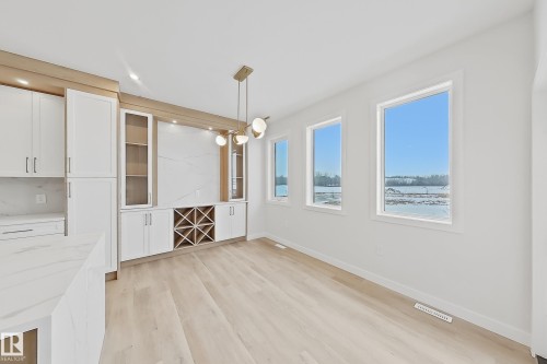 The property features light wood flooring and white walls, creating a bright and airy atmosphere - 17 Trill Point(E), Spruce Grove, AB - Indoor Photo Showing Other Room