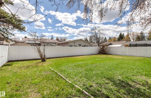 Expansive lawn area featuring a full-height white privacy fence - 29 Bristow Crescent, Spruce Grove, AB - Outdoor