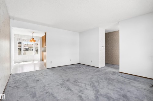 Expansive main living area featuring grey carpet flooring and white walls - 29 Bristow Crescent, Spruce Grove, AB - Indoor Photo Showing Other Room