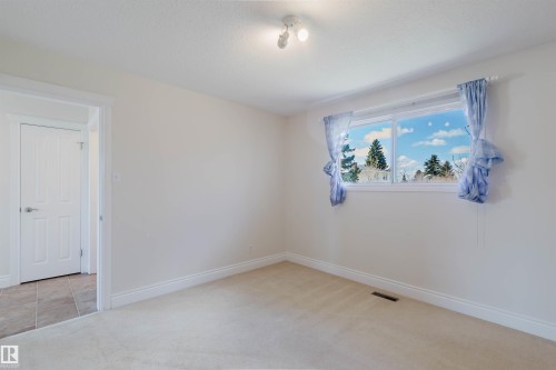 Room featuring light beige carpet flooring, white baseboards, and neutral wall paint - 3752 114 Street, Edmonton, AB - Indoor Photo Showing Other Room