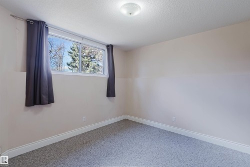 Room featuring light neutral wall tones and a window with exterior tree scenery - 3752 114 Street, Edmonton, AB - Indoor Photo Showing Other Room