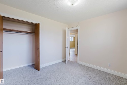 Bedroom featuring light-colored walls and patterned carpeting - 3752 114 Street, Edmonton, AB - Indoor Photo Showing Other Room