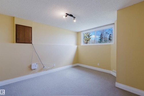 Room featuring light-colored carpet, painted walls with white trim, and a horizontal window with exterior scenery - 3752 114 Street, Edmonton, AB - Indoor Photo Showing Other Room