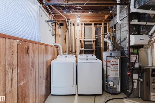 Dedicated utility area with wood-finish paneling and exposed ceiling joists - 3752 114 Street, Edmonton, AB - Indoor Photo Showing Other Room